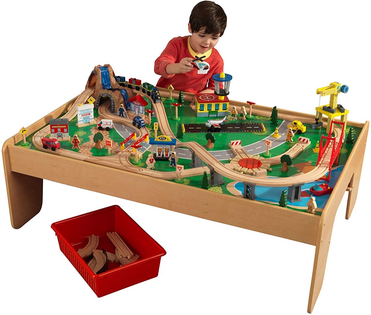 kid playing with wooden train table