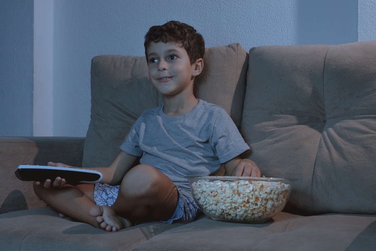 Child Watching TV and Eating Popcorn Late at night