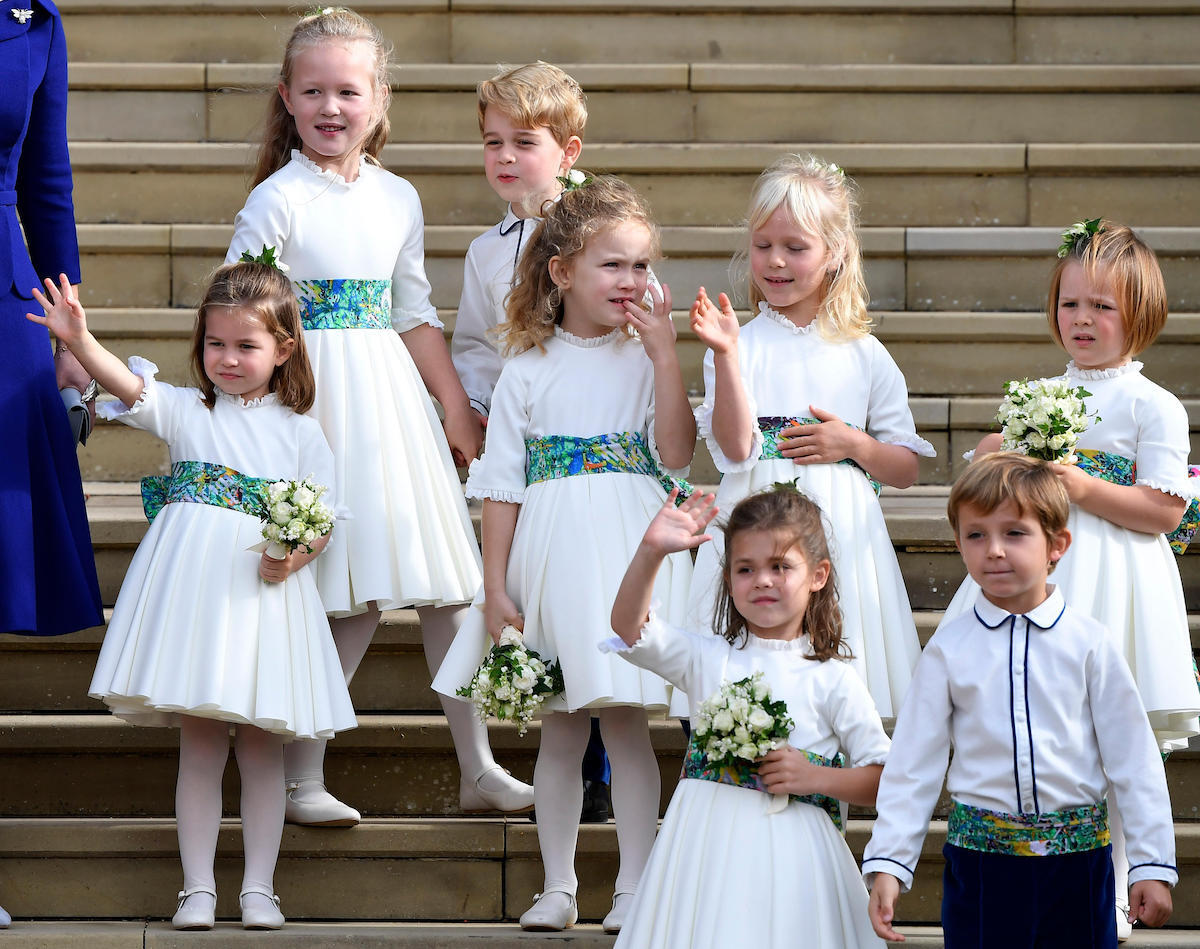 The bridesmaids and page boys, including Prince George and Princess Charlotte, wave as they leave after the royal wedding of Princess Eugenie and her husband Jack Brooksbank at St George's Chapel in Windsor Castle.