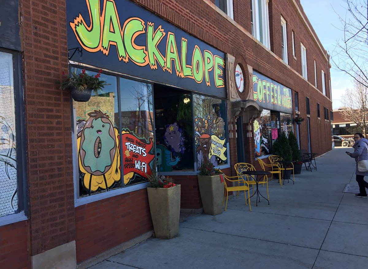 exterior storefront of jackalope coffee in chicago with window art donut