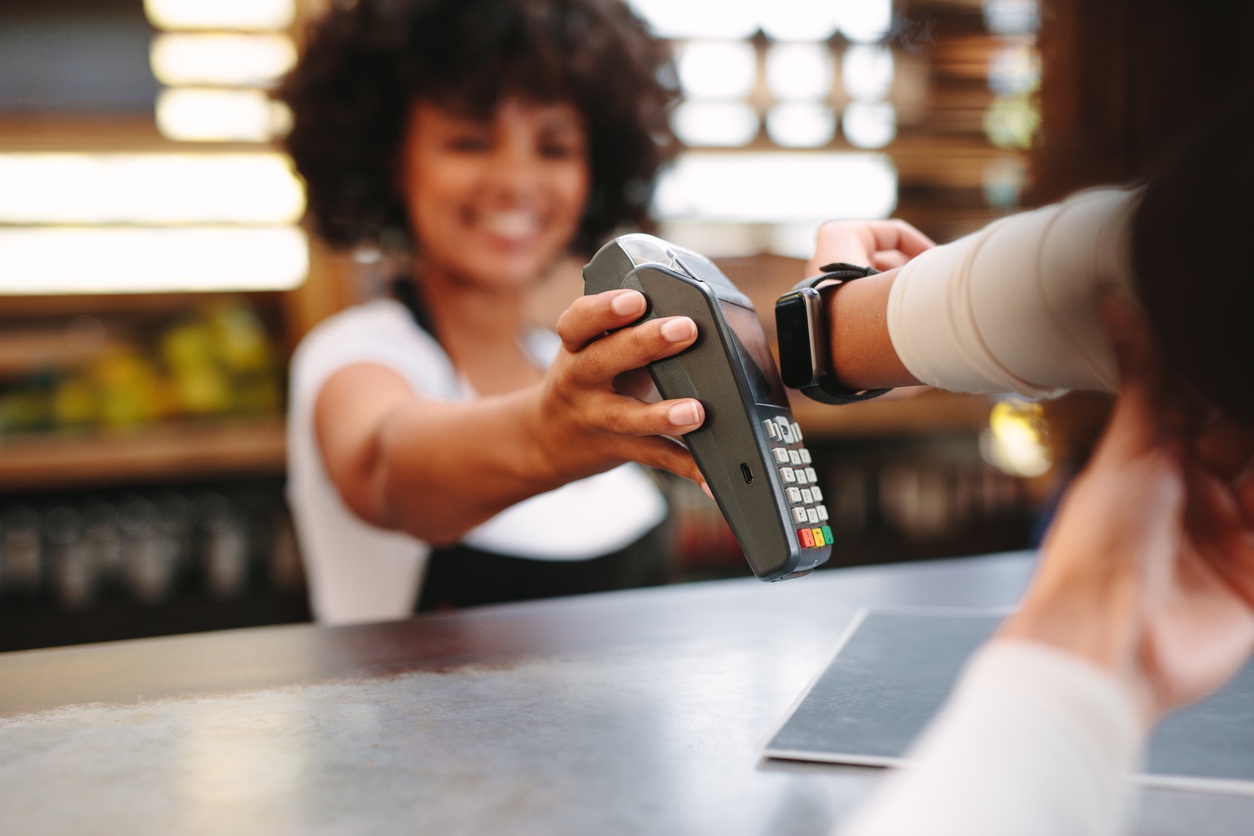 A customer using their smartwatch to pay at a store