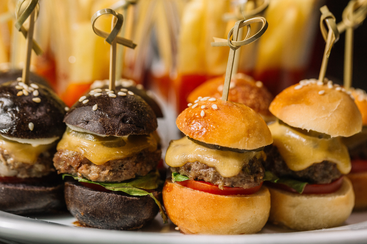 Sliders, mini burgers, half with black buns, half with white buns