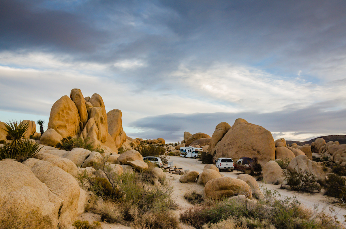 Dramatic clouds over campsites in White Tank Campground as evening falls at Joshua Tree National Park.