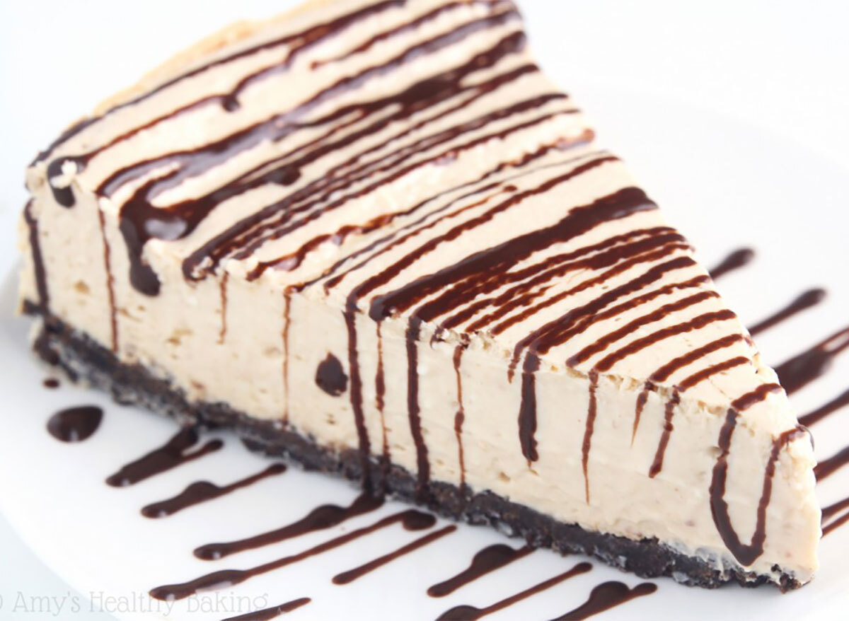 slice of peanut butter cheesecake topped with chocolate drizzle
