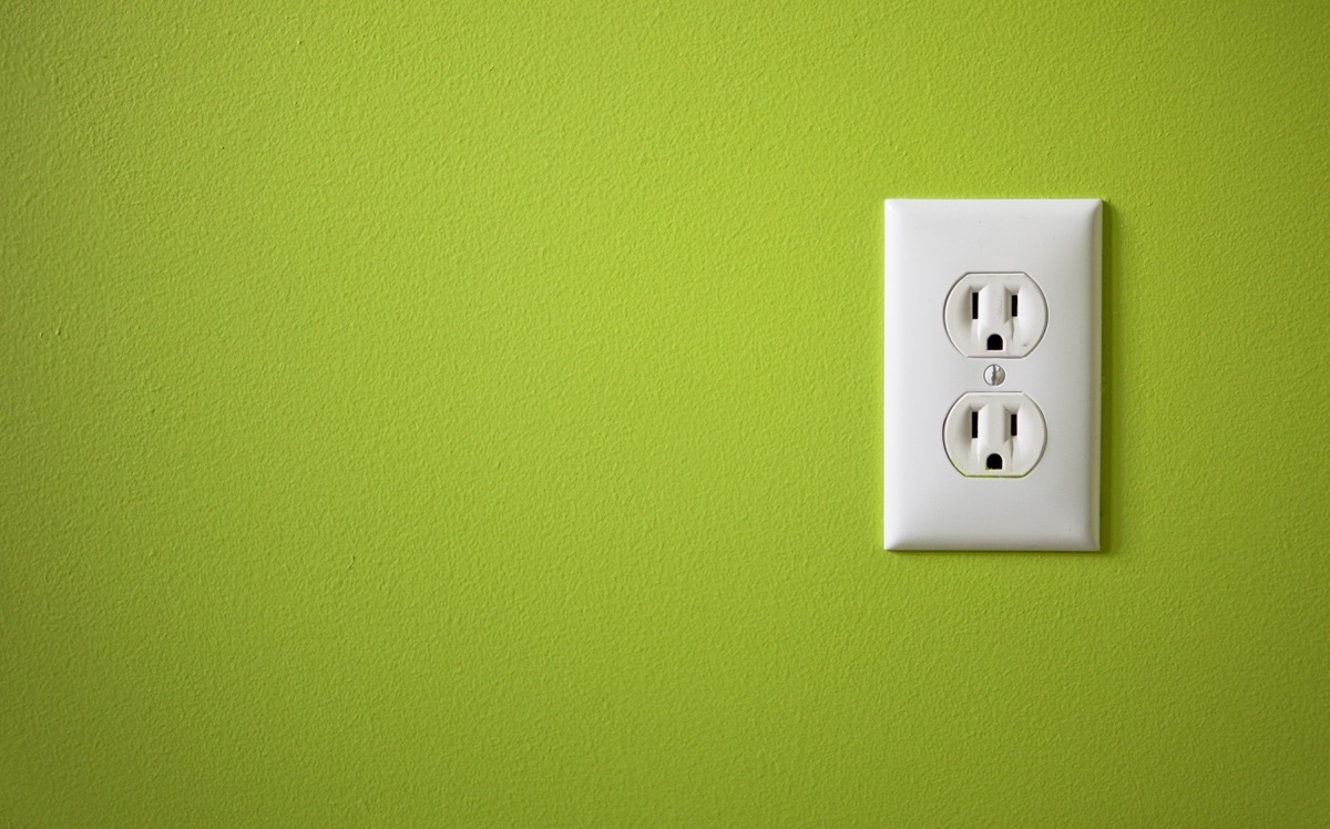 Electrical outlet on green wall