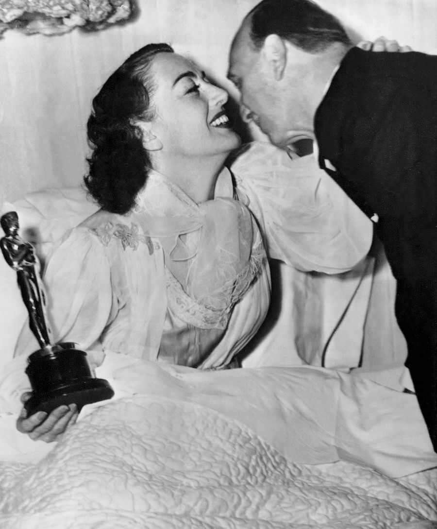 Joan Crawford and Michael Curtiz with her Oscar in 1946