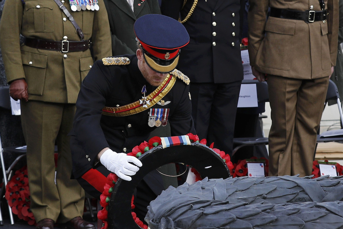 Britain's Prince Harry lays a wreath on the Armed Forces Memorial during a service of remembrance on Armistice Day at the National Memorial Arboretum, in Alrewas, central England on November 11, 2016