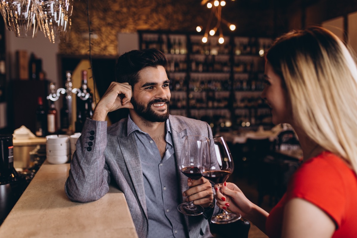 man and woman on a date drinking red wine