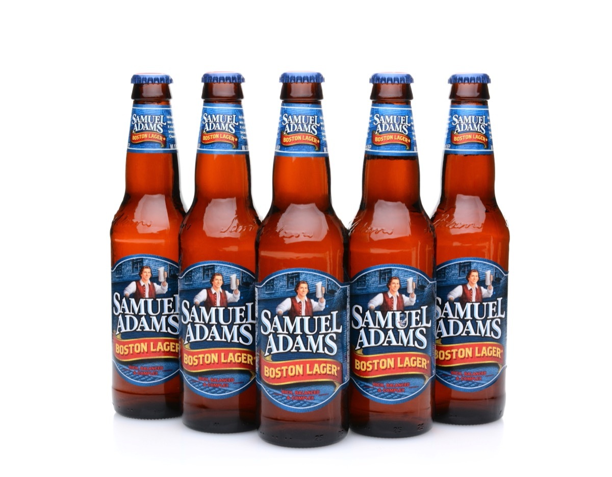 five bottles of sam adams boston lager on white background