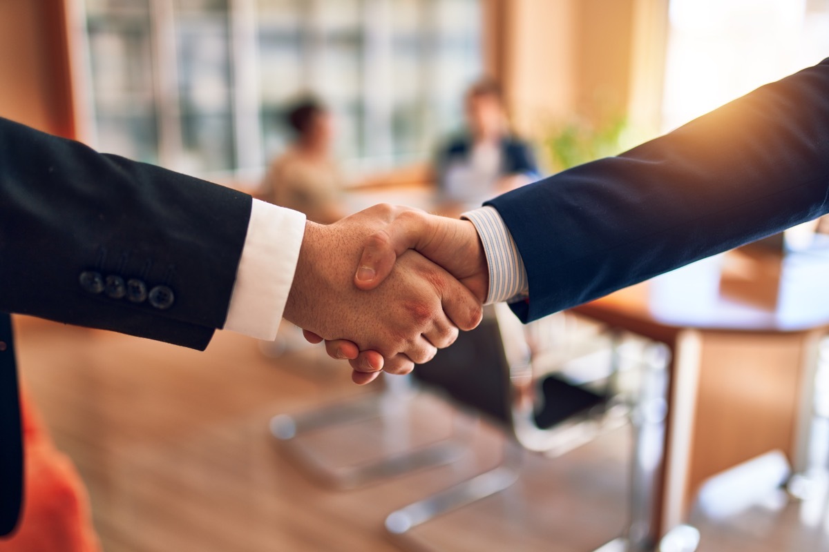 two men in suits shaking hands