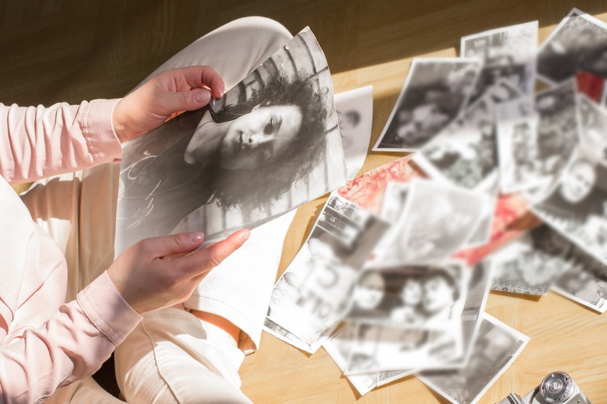 young woman sitting on the floor looking at pictures