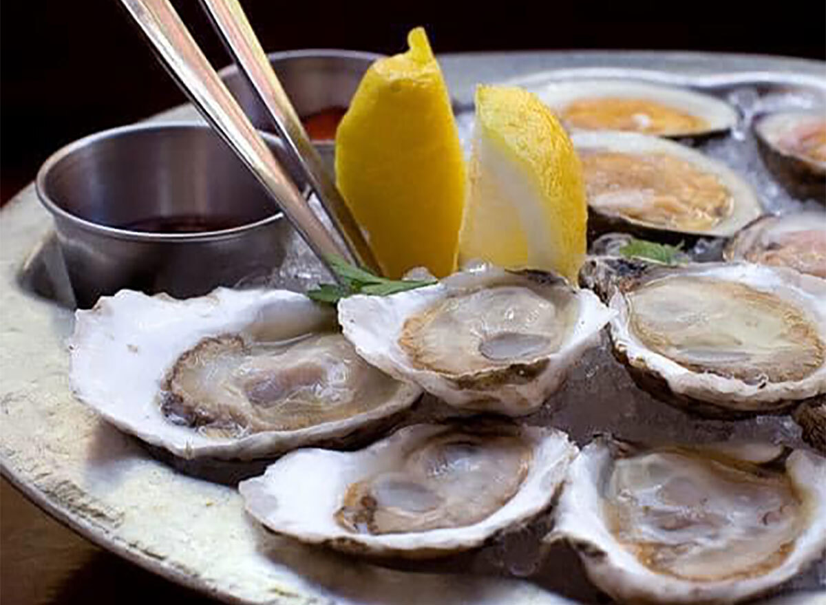 platter of oysters with lemon wedges