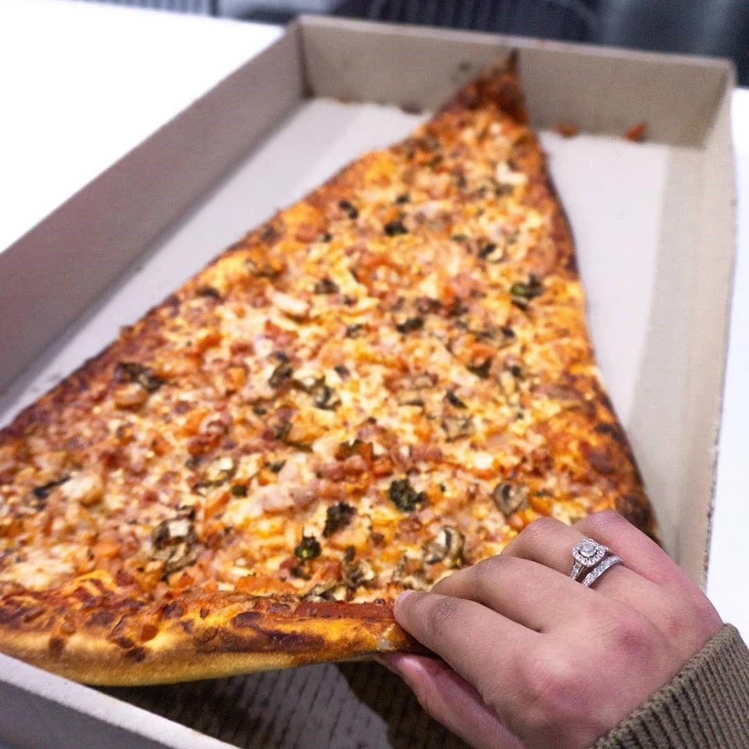 Slices cost over $20 | New Foodie Trend Is A Giant Pizza Slice – The Biggest You've Seen | Her Beauty