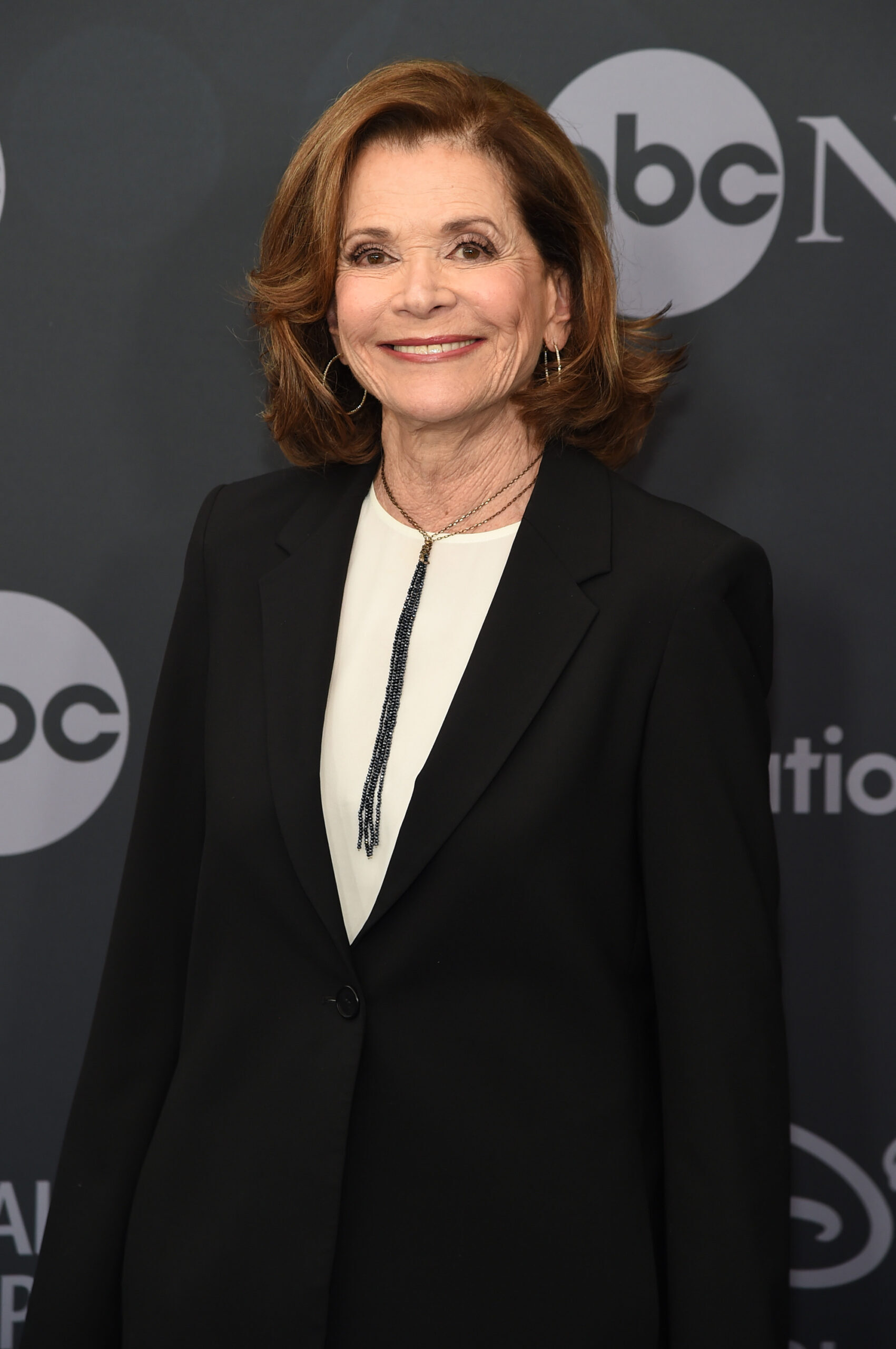 jessica walter in white top and black jacket in front of abc step-and-repeat