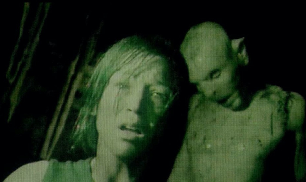 woman and monster in night vision still from the descent