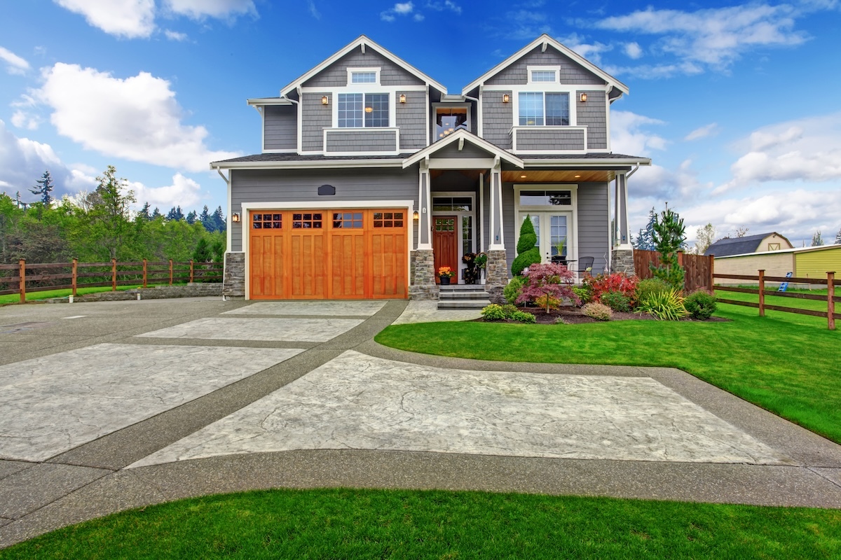 house exterior with a large, paved driveway