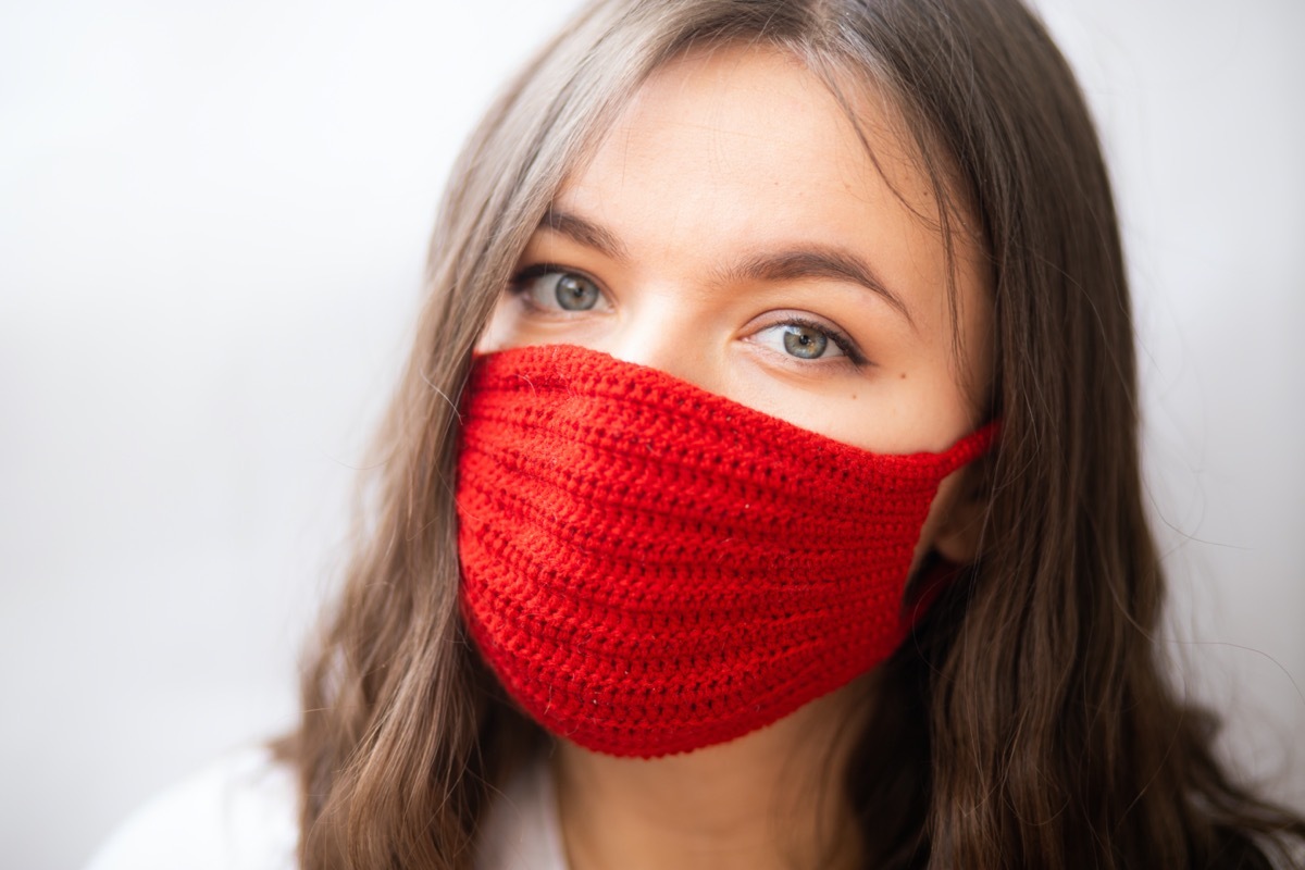 Woman wearing knitted face mask