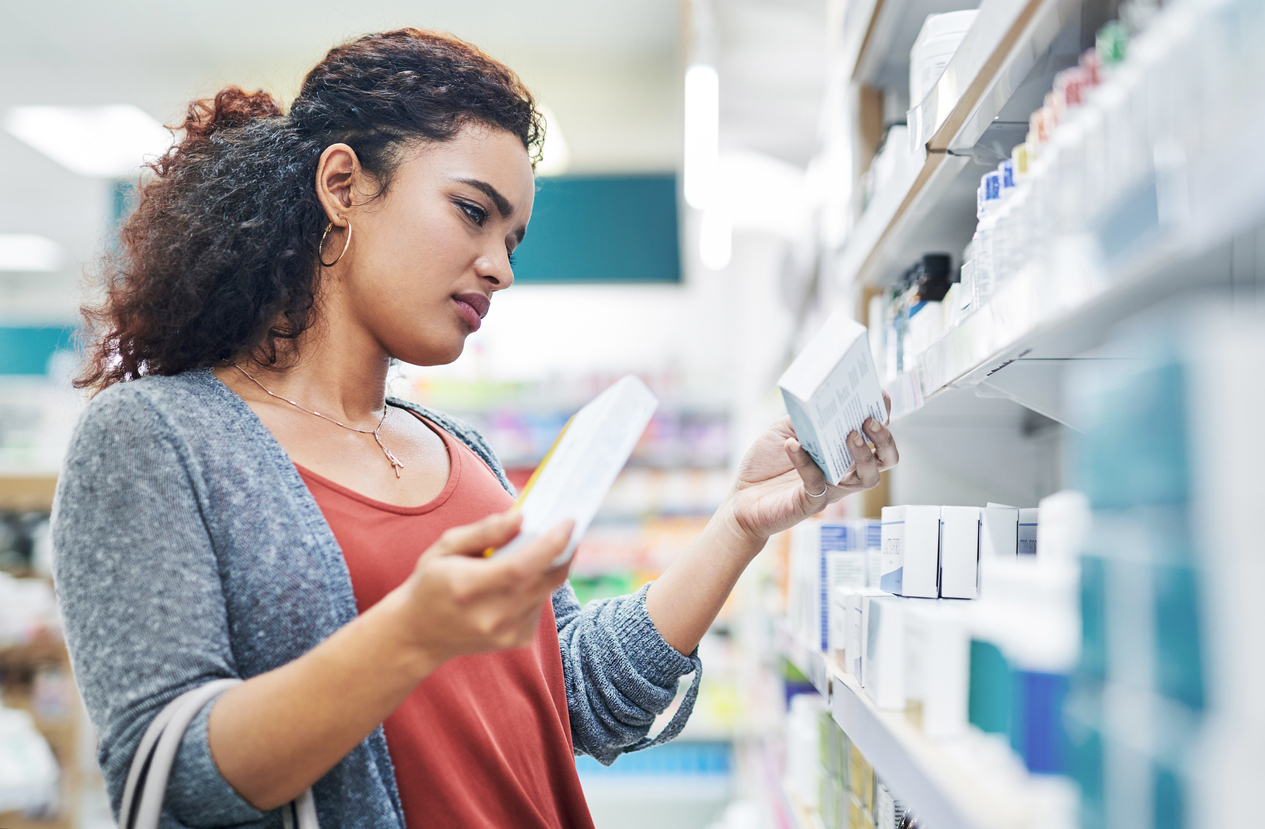 A woman shopping in the pharmacy for over-the-counter medication