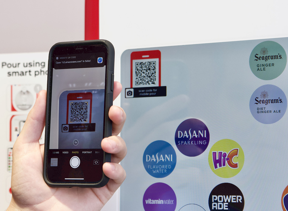 scanning QR code on contactless soda machine