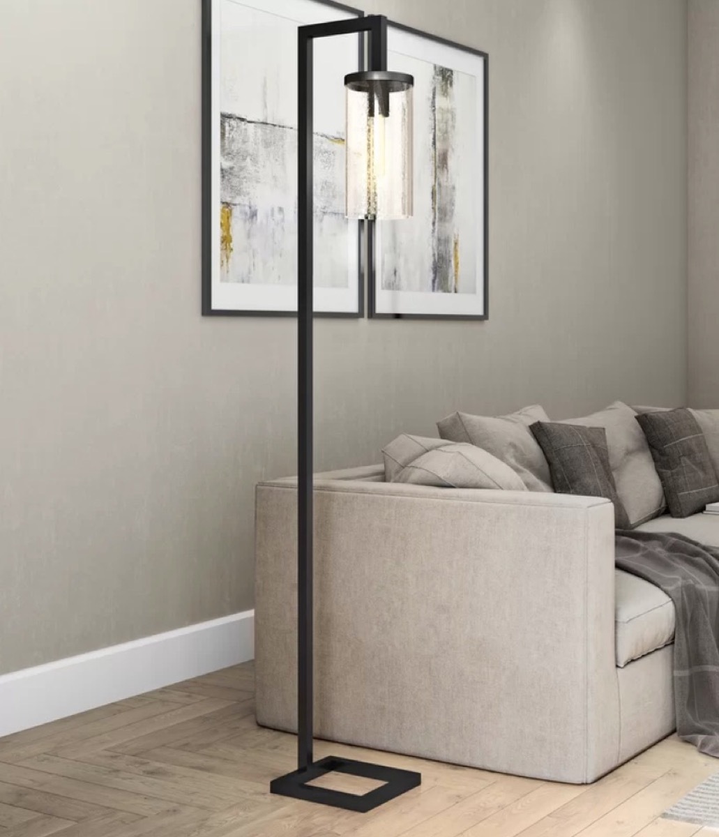 black floor lamp next to gray couch