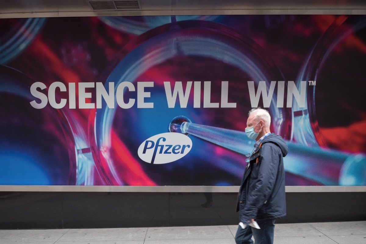 Manhattan, New York. November 27, 2020. A man walks in front of Pfizer headquarter in Midtown.