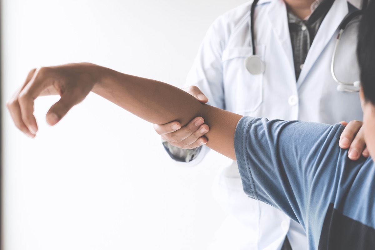 Doctor checking patient with elbow to determine the cause of illness.