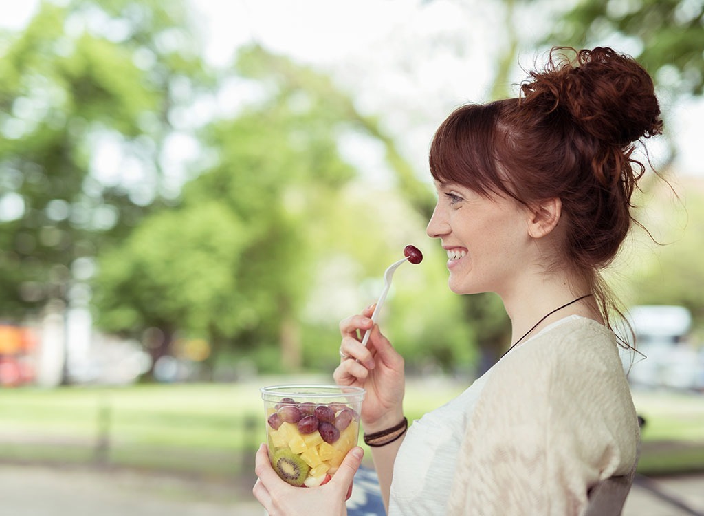 woman snacking on fruit