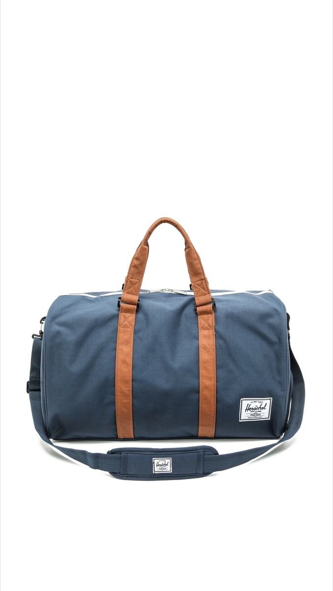 blue weekender with brown leather straps