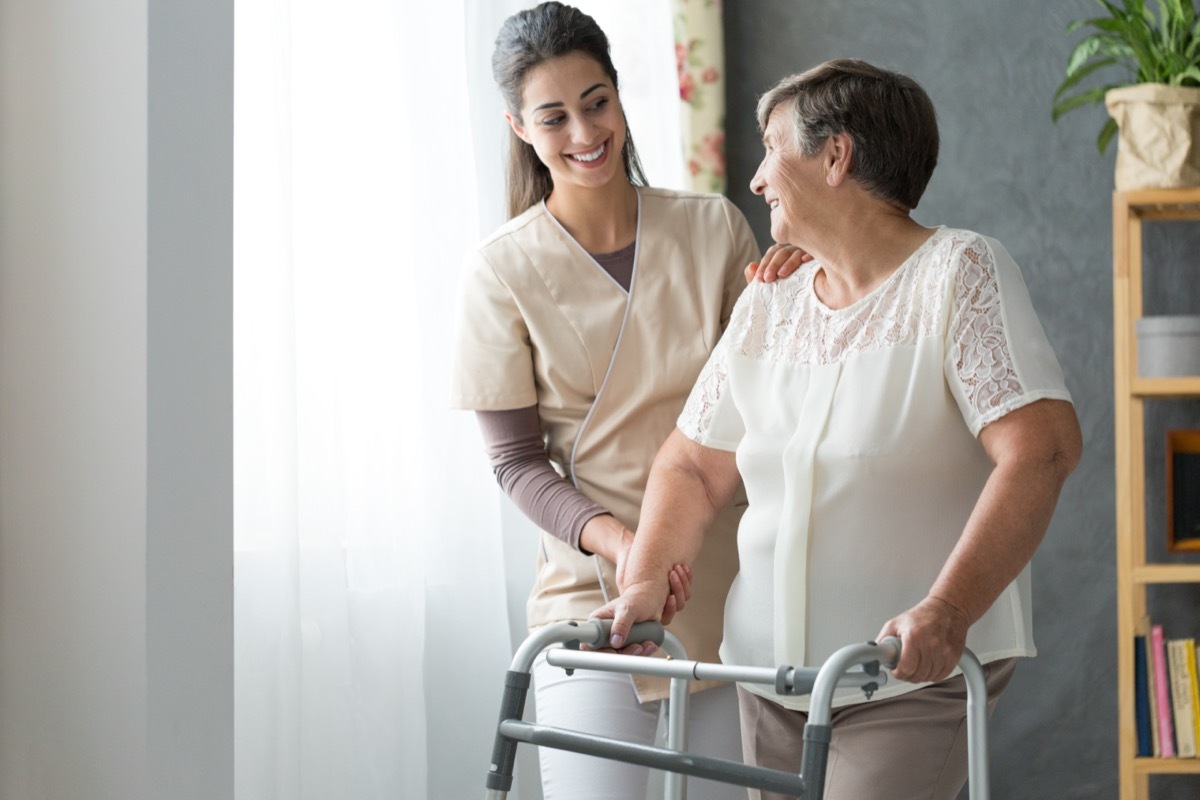 Worker helping a woman in a nursing home