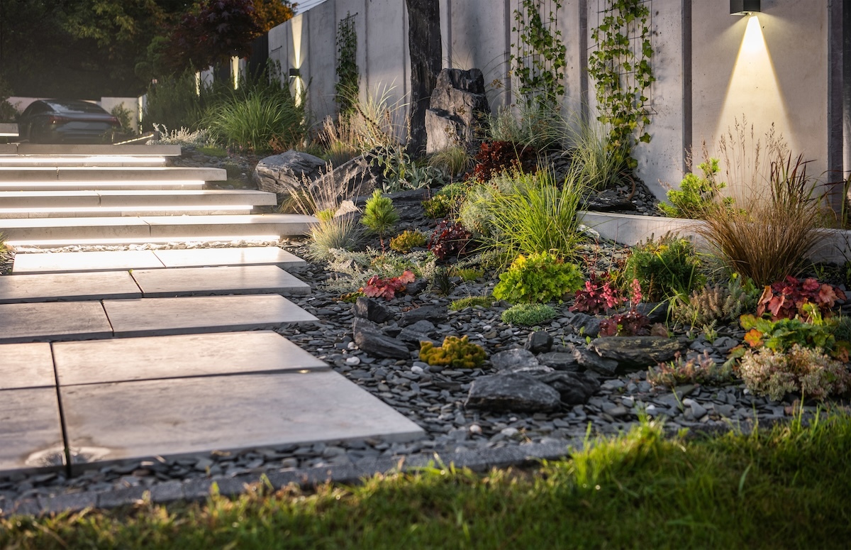 light gray stone or concrete steps in a backyard, lit up by LED lights