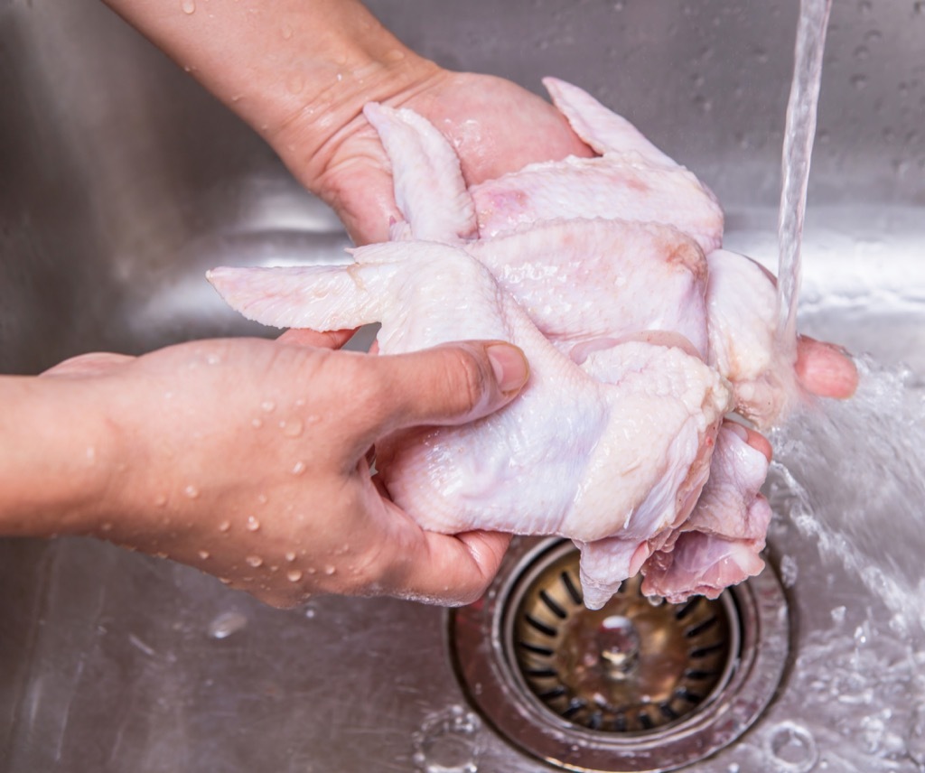 washing chicken in a sink