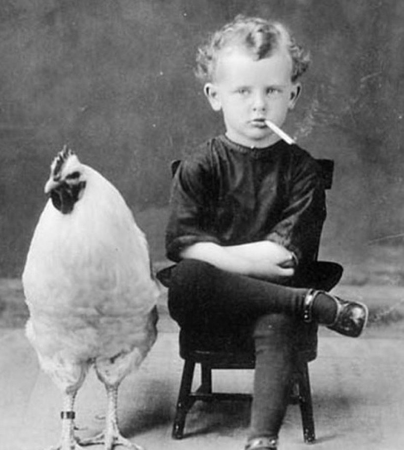 Kid smoking with his chicken vintage family photo