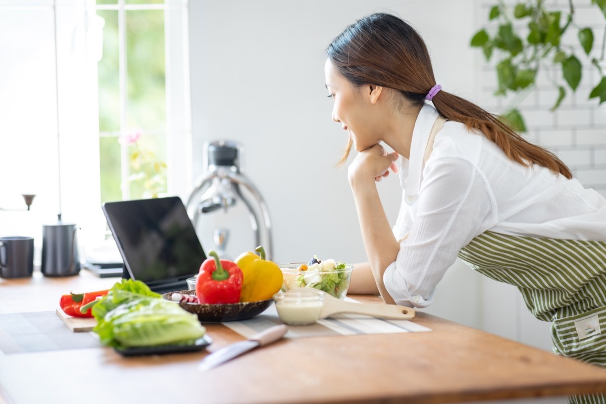 woman attending a virtual cooking class in her kitchen