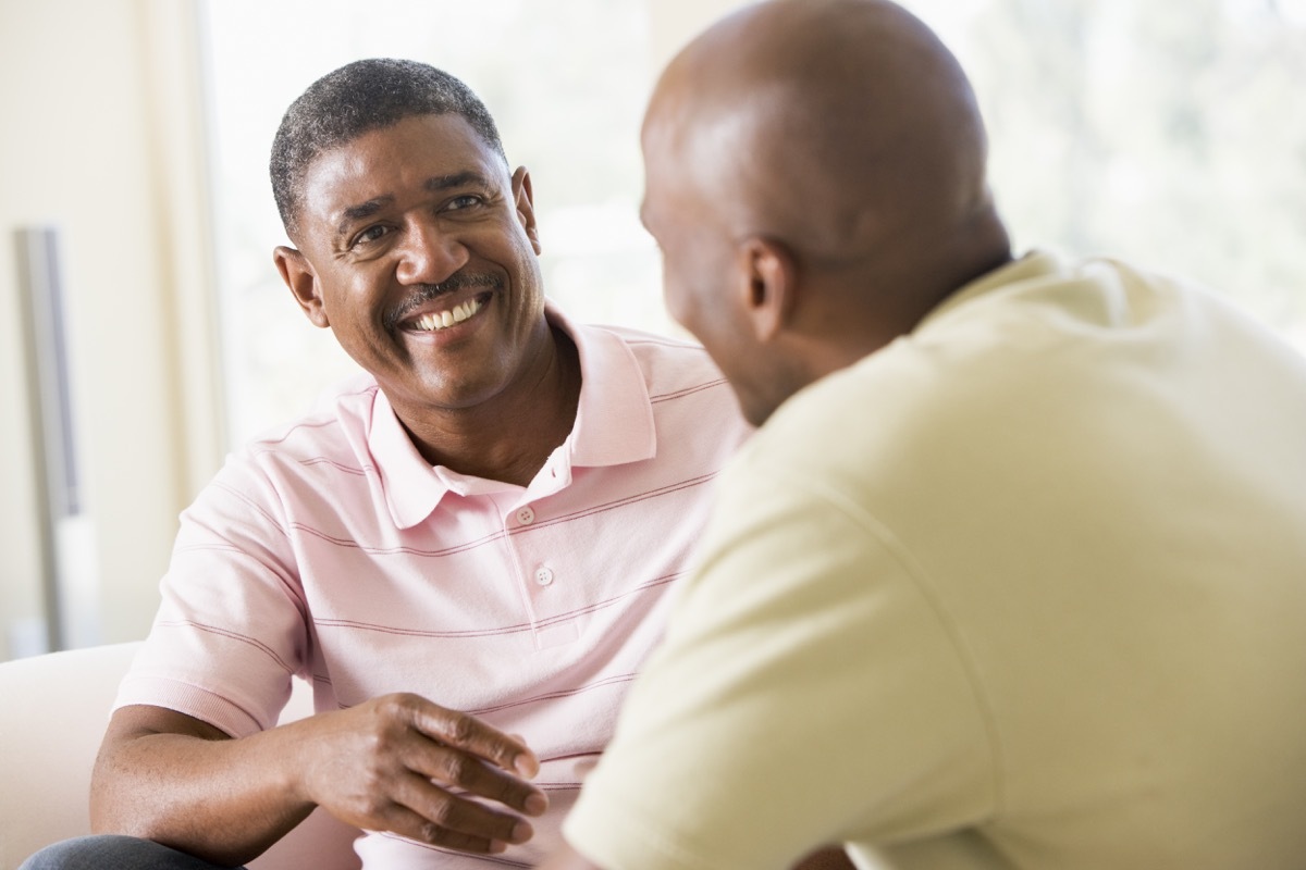Middle age black men talking smiling