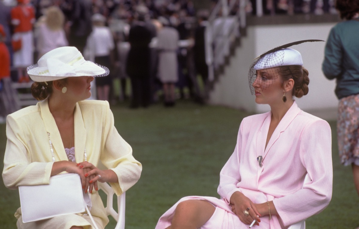women sitting outside wearing pastel suits with large shoulder pads