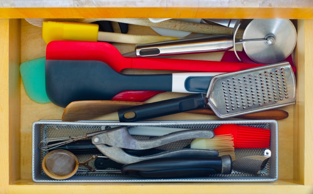 cluttered kitchen drawer, spatulas, downsizing your home