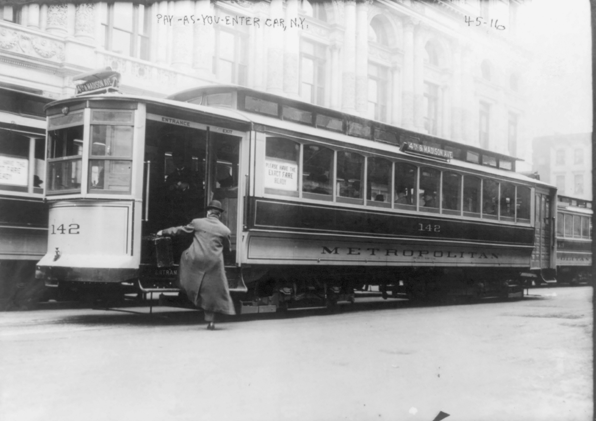 a man gets on a streetcar in new york