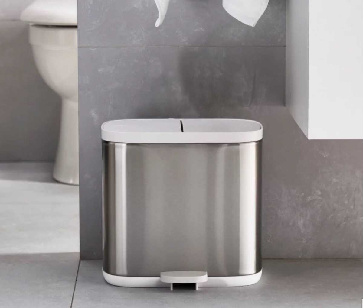 silver trash can with white top in a modern bathroom, bathroom accessories