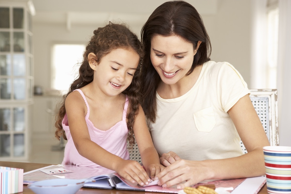 Mother and daughter creating a scrapbook together