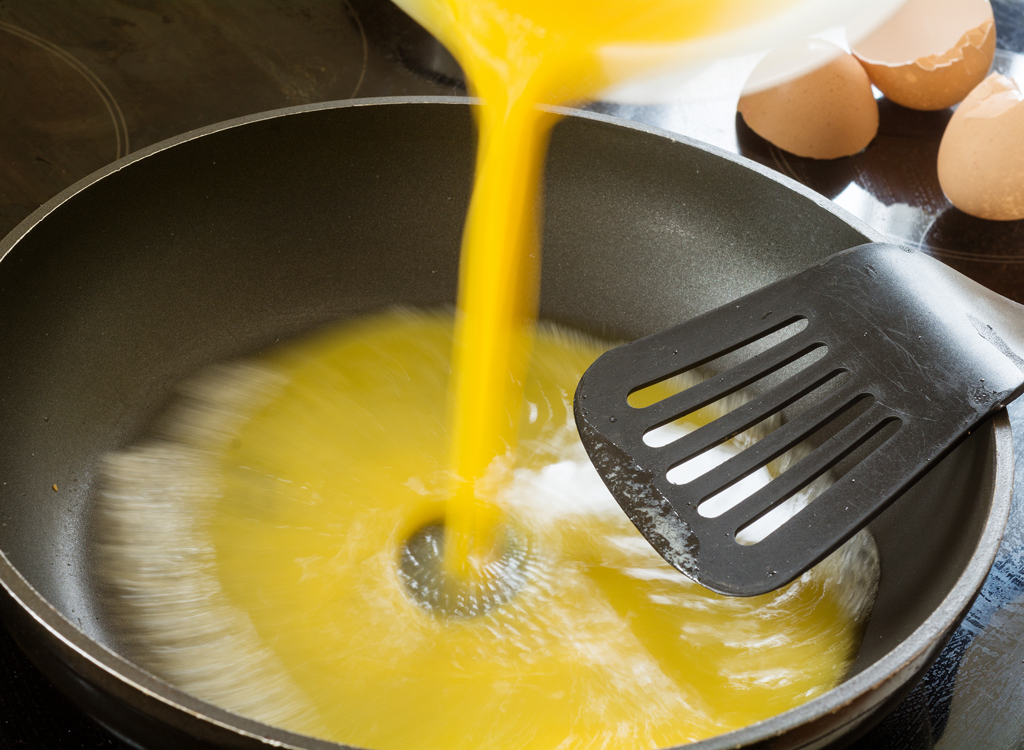 Pour scrambled eggs into pan stir