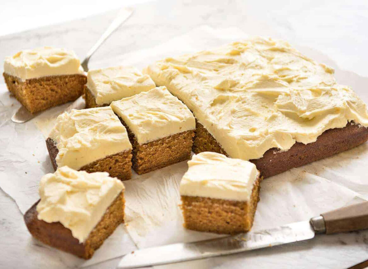 pumpkin cake with cream cheese frosting cut into squares