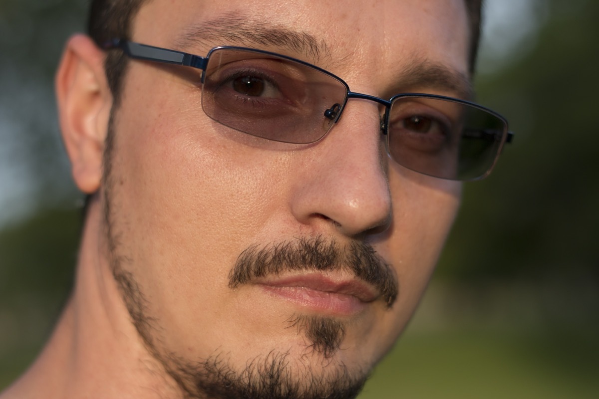 man with a goatee wearing transition lenses