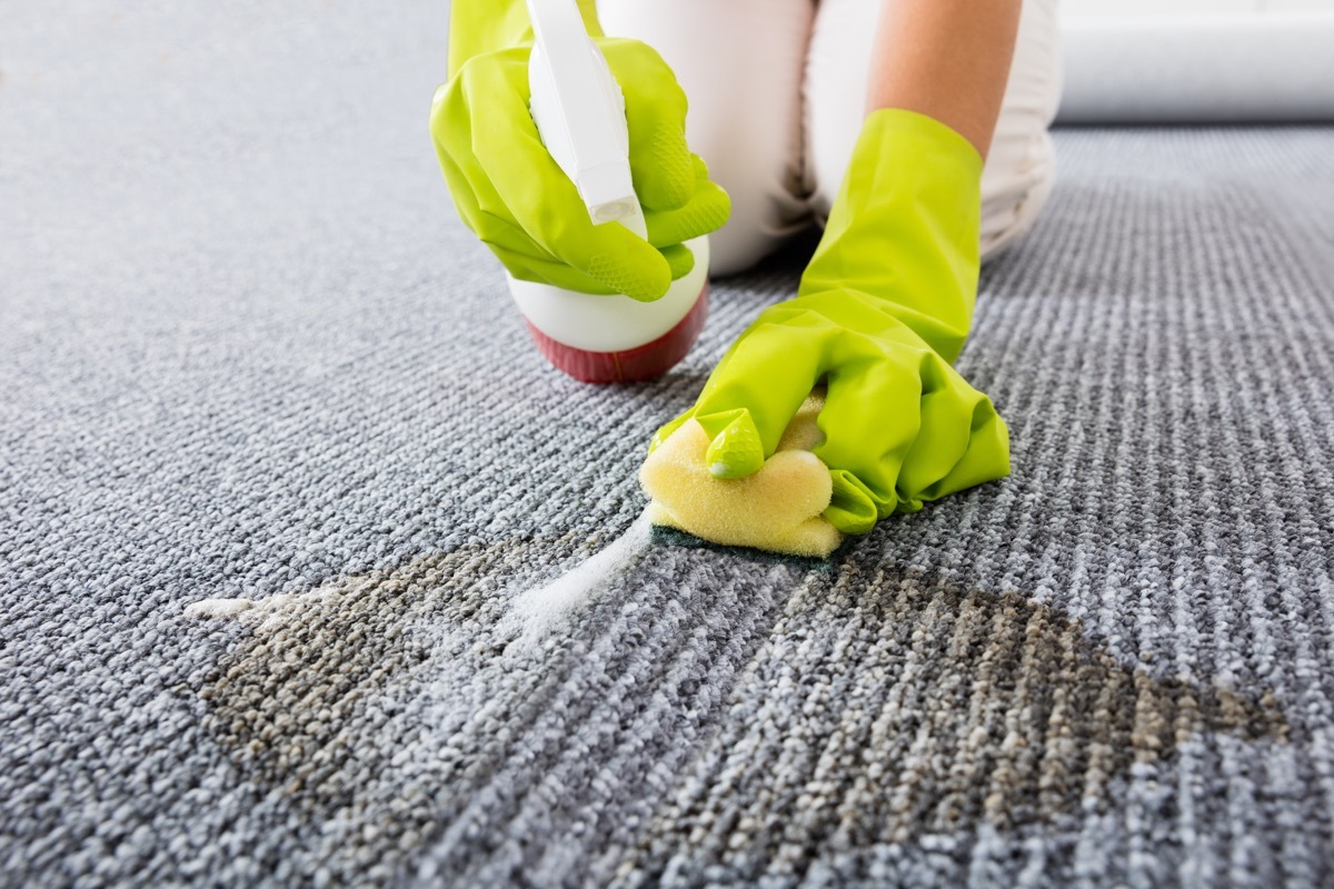 woman scrubbing carpet