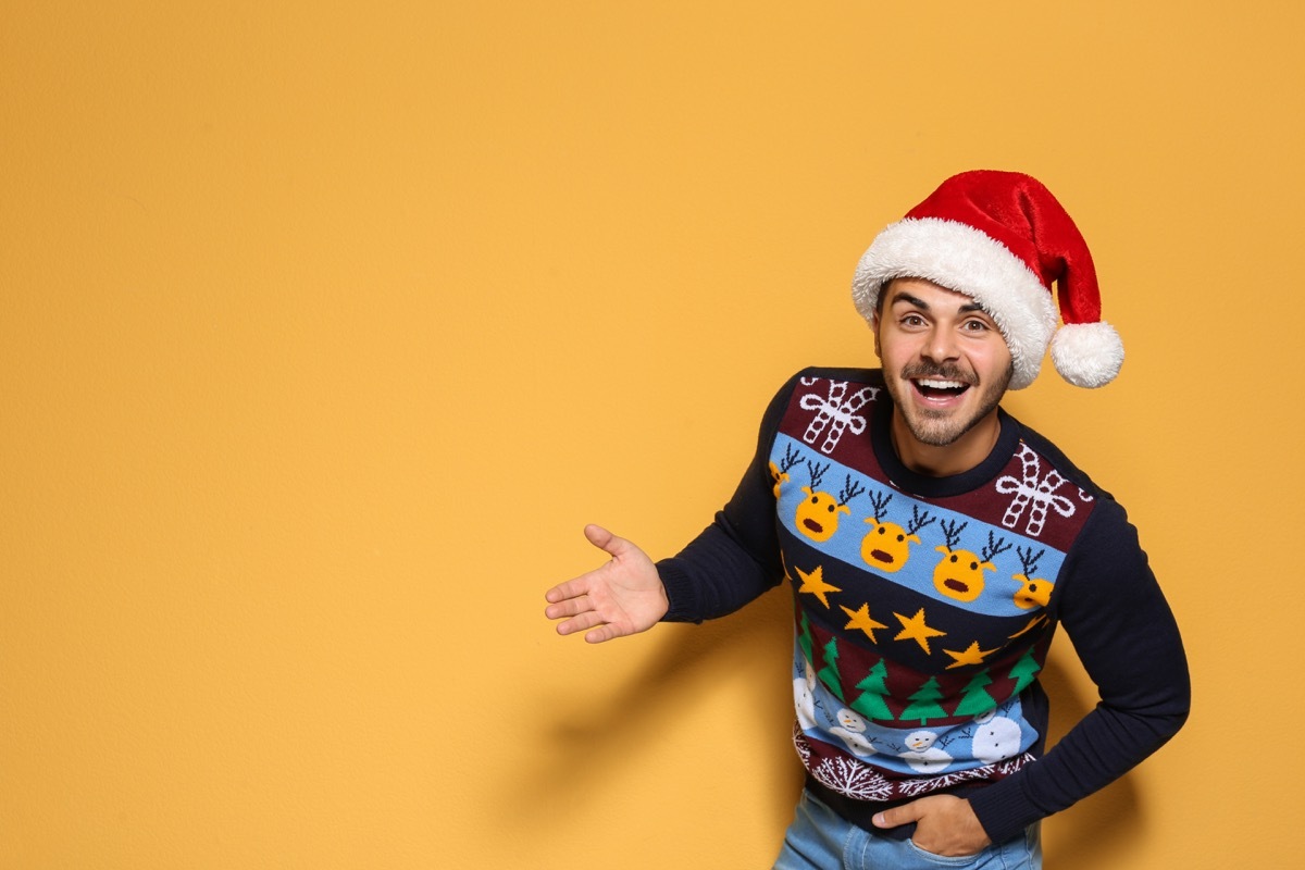 man wearing a santa hat and a christmas sweater