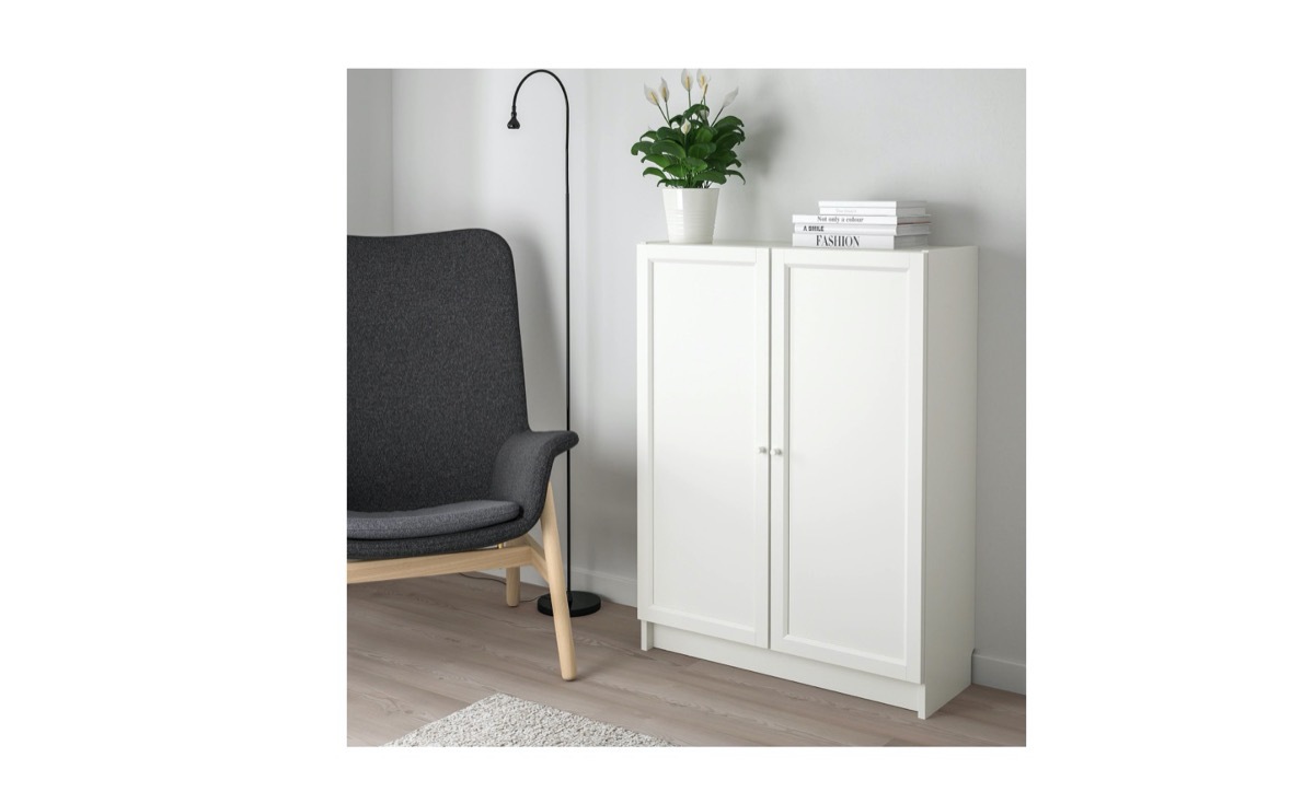 ikea billy bookcase in modern room next to gray chair