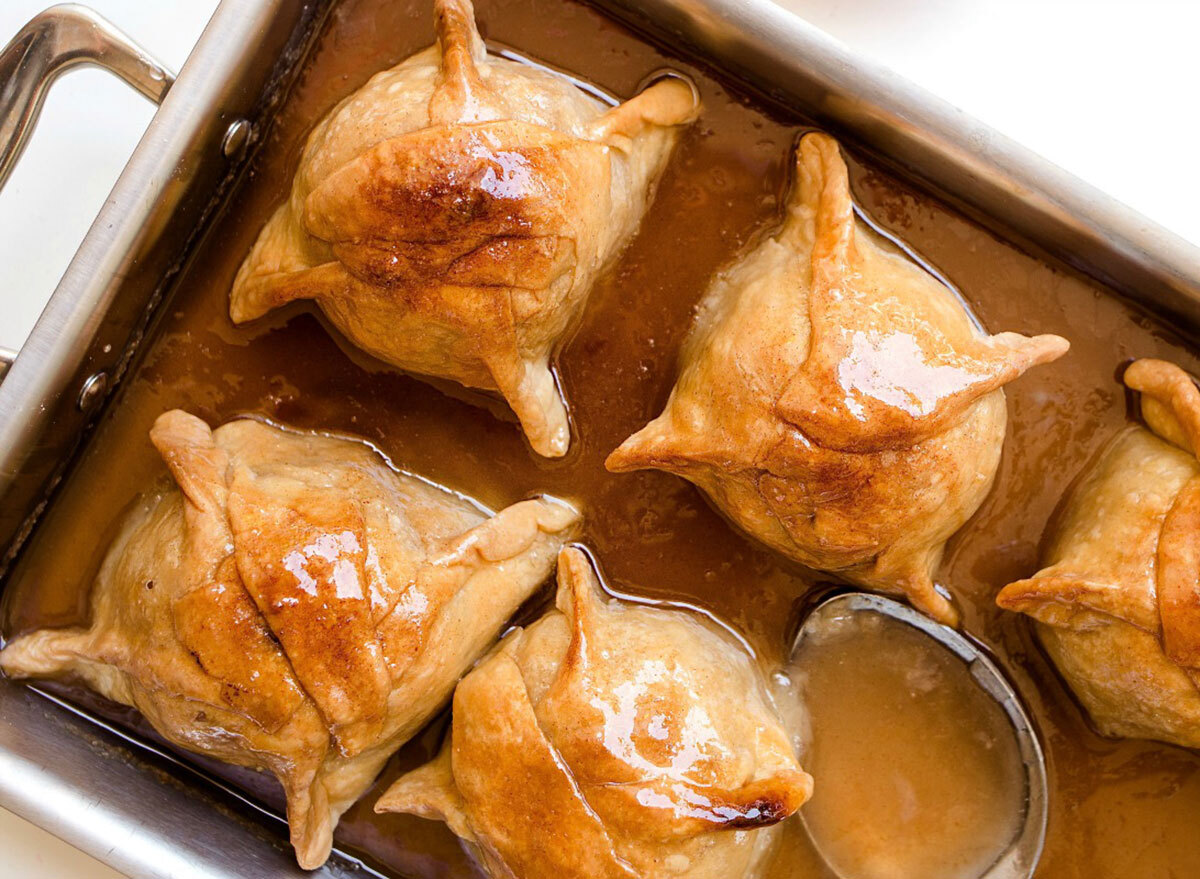 apple dumplings on baking pan with glaze