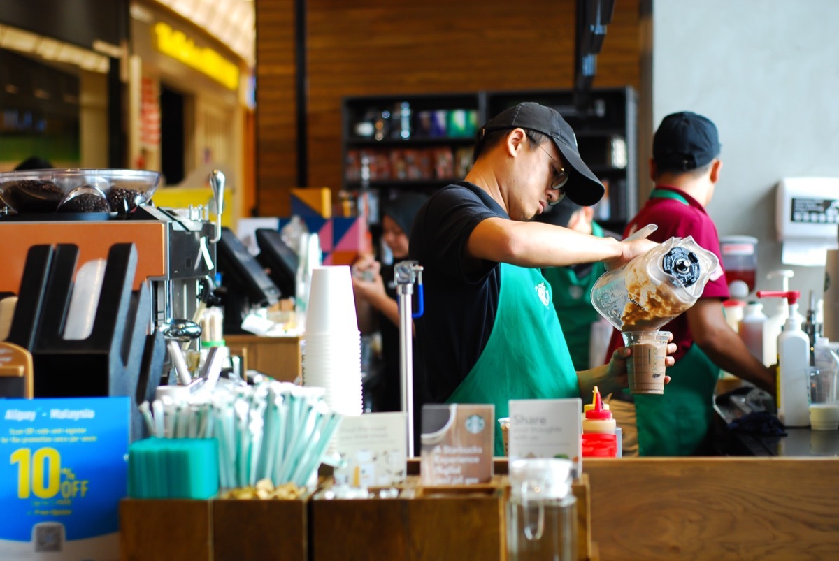 SEREMBAN,MALAYSIA - SEPTEMBER 18, 201T: Worker at Starbucks Cafe preparing coffee for customers.Starbucks is an American global coffee company and coffeehouse chain based in Seattle, Washington