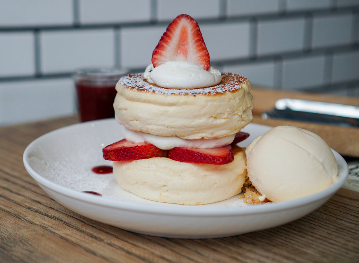 stack of fluffy japanese souffle pancakes with strawberry slices