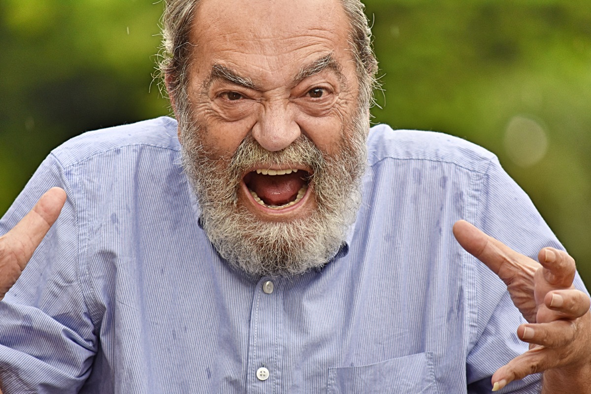 Angry older man yelling at someone or something